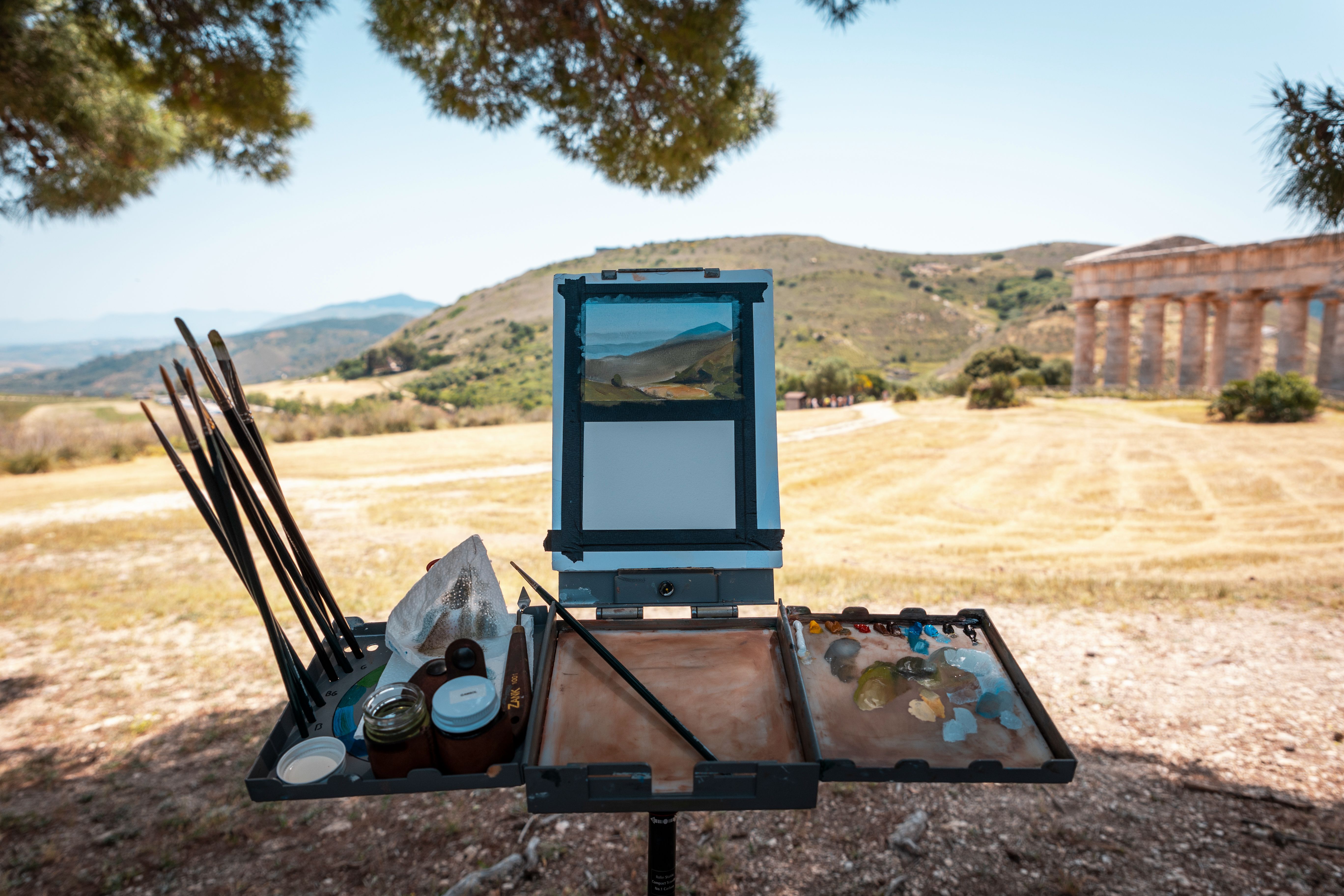 outdoor painting setup by ancient Sicilian building